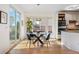 Bright dining area with a glass table, bay window, and convenient access to the kitchen at 4340 Nelson Dr, Broomfield, CO 80023