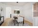 Cozy dining room with a dark wood table, white chairs, and a stylish chandelier at 4340 Nelson Dr, Broomfield, CO 80023