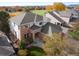 Aerial view of a two-story home featuring brick accents, a well-manicured lawn, and mature trees at 4340 Nelson Dr, Broomfield, CO 80023