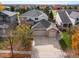 Aerial view of a two-story home with brick accents, mature trees, and a three-car garage at 4340 Nelson Dr, Broomfield, CO 80023