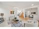 Bright living room with modern lighting, neutral tones, and open access to other living areas at 4340 Nelson Dr, Broomfield, CO 80023