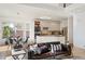 Open-concept living room with modern kitchen, granite counters, and stainless steel appliances at 4340 Nelson Dr, Broomfield, CO 80023
