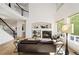 Bright living room boasts a fireplace, high ceilings, large windows, and an open floor plan at 4340 Nelson Dr, Broomfield, CO 80023