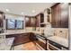 Modern kitchen featuring granite countertops and stainless steel appliances at 12658 W 84Th Dr, Arvada, CO 80005