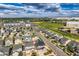 An aerial view showcases a neighborhood filled with houses under a partially cloudy, blue sky at 4404 Walden St, Denver, CO 80249