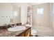 Bathroom with a shower-tub combination, single sink, and large mirror, designed for functionality at 4404 Walden St, Denver, CO 80249