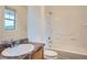 Well-lit bathroom featuring a single sink vanity, and shower over tub at 4404 Walden St, Denver, CO 80249
