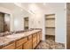 Bathroom with double sink vanity with granite countertops, tile flooring and a separate shower with tile surround at 4404 Walden St, Denver, CO 80249