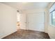 Bedroom featuring closet and an open door leading to a bathroom, all with neutral carpet at 4404 Walden St, Denver, CO 80249