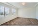 Spacious bedroom featuring carpet flooring, a ceiling with a tray, and window with blinds at 4404 Walden St, Denver, CO 80249