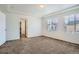 Bright bedroom featuring carpet flooring, a ceiling with a tray, and window with blinds at 4404 Walden St, Denver, CO 80249
