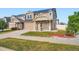 Two story home with large green lawn and stone and siding exterior, complemented by a two car garage at 4404 Walden St, Denver, CO 80249