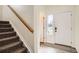 Bright foyer featuring hardwood floors, staircase, and a white front door with side window at 4404 Walden St, Denver, CO 80249
