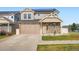 Charming two-story home featuring stone accents, a two-car garage, and solar panels for energy efficiency at 4404 Walden St, Denver, CO 80249