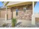 Close-up of the front entrance showcasing stone siding, a covered porch, and well-maintained landscaping at 4404 Walden St, Denver, CO 80249