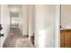 Hallway with carpet leading to a living room and view of the upstairs staircase at 4404 Walden St, Denver, CO 80249