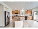 Well-lit kitchen boasts stainless steel appliances, granite countertops, and light hardwood-style flooring at 4404 Walden St, Denver, CO 80249
