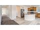 Open kitchen layout featuring stainless steel appliances, granite countertops, and light hardwood-style flooring at 4404 Walden St, Denver, CO 80249