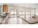 Bright kitchen with granite countertops, stainless steel sink, and sliding glass door to backyard patio at 4404 Walden St, Denver, CO 80249