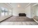 Living room showcasing the transition from wood flooring to carpet and a brown couch at 4404 Walden St, Denver, CO 80249
