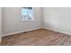 Simple bedroom with wood-look flooring and a window at 3484 N Irvington St, Aurora, CO 80019