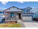 Two-story house with gray siding, stone accents, and a two-car garage at 3484 N Irvington St, Aurora, CO 80019