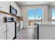 Modern kitchen features stainless steel appliances and vinyl plank flooring at 3484 N Irvington St, Aurora, CO 80019