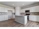 Modern kitchen with island, stainless steel appliances, and vinyl plank flooring at 3484 N Irvington St, Aurora, CO 80019