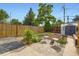 Charming backyard setting with mature trees, garden area, hardscape patio, and shed at 1021 Stuart St, Denver, CO 80204