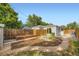 Fenced backyard with a wooden fence, garden beds, shed and patio offers outdoor living at 1021 Stuart St, Denver, CO 80204