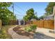Private backyard showcasing a storage shed, garden, wooden fence and stone path at 1021 Stuart St, Denver, CO 80204