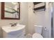 Bathroom featuring a modern vanity, toilet, and framed mirror with decorative shelving accents at 1021 Stuart St, Denver, CO 80204