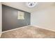 Comfortable carpeted bedroom with a window and a dark accent wall complemented by white walls at 1021 Stuart St, Denver, CO 80204