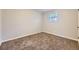 Standard empty bedroom with neutral carpet and a window providing natural light at 1021 Stuart St, Denver, CO 80204