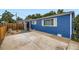 Attractive blue home featuring a private driveway and modern landscaping with charming wooden accents at 1021 Stuart St, Denver, CO 80204