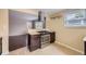 Modern kitchen featuring stainless steel appliances and dark wood cabinets with a peninsula counter at 1021 Stuart St, Denver, CO 80204