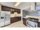 Modern kitchen featuring stainless steel appliances and dark wood cabinets with a peninsula counter at 1021 Stuart St, Denver, CO 80204