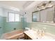 Retro bathroom featuring tile walls, a bathtub, and a vanity with plenty of counter space at 6212 S Pennsylvania St, Centennial, CO 80121