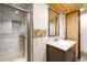 Bathroom with tiled shower, modern vanity, and wood accent ceiling at 6212 S Pennsylvania St, Centennial, CO 80121