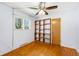 Bedroom with hardwood floors, ceiling fan, and a window that brings in natural light at 6212 S Pennsylvania St, Centennial, CO 80121