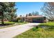 A wide concrete driveway leads to an attached garage with brick facade at 6212 S Pennsylvania St, Centennial, CO 80121
