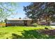 Charming single-story brick home with a well-manicured lawn and mature trees at 6212 S Pennsylvania St, Centennial, CO 80121