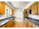 Functional kitchen with wooden cabinets, laminate countertops, and stainless steel appliances at 6212 S Pennsylvania St, Centennial, CO 80121