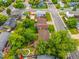 Aerial view showcasing home's fenced backyard, lush lawn, and mature trees in a neighborhood at 9832 High St, Thornton, CO 80229