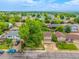 Aerial view displaying the home's driveway, front yard landscaping, and quiet neighborhood setting at 9832 High St, Thornton, CO 80229