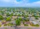 Expansive aerial view showcases a neighborhood setting with tree-lined streets and well-maintained homes at 9832 High St, Thornton, CO 80229
