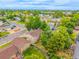 Aerial view of home reveals large backyard with garden area, mature trees, and neighborhood setting at 9832 High St, Thornton, CO 80229