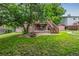 The backyard features green grass, a patio, a deck, stairs, and a fire pit at 9832 High St, Thornton, CO 80229
