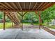 Spacious backyard featuring a wood deck, wood staircase, firepit and lots of green grass at 9832 High St, Thornton, CO 80229