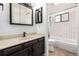 Bright bathroom with white tiled walls, black trim, and modern vanity at 9832 High St, Thornton, CO 80229